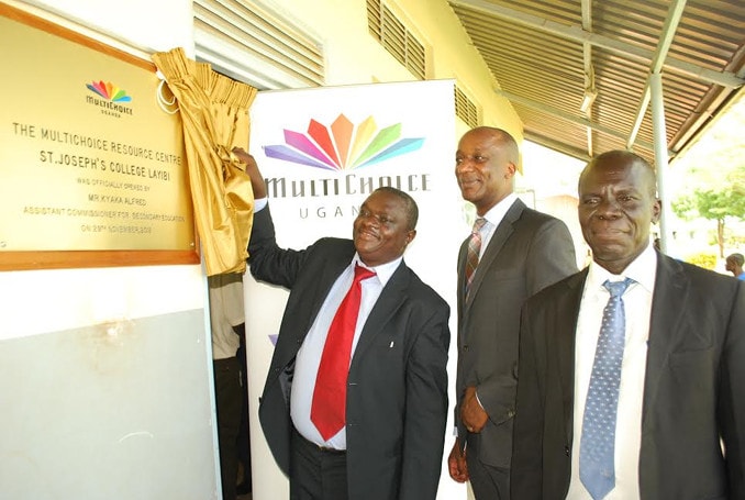 The Assistant Commissioner for Secondary Education Mr. Alfred Kyaka (left) unveils a plaque at the launch of the MultiChoice Resource Centres in Northern Uganda, Gulu district at St Joseph’s College Layibi School. Fifteen schools in the region have had digital learning equipment installed in their classrooms and turned into MultiChoice Resource Centers. Looking on is the MultiChoice Uganda General Manager Mr Charles Hamya (centre) and the Head Teacher St Joseph’s College Layibi School Mr. Robert Ojok (right). The MultiChoice Resource Centres programme is a continental Corporate Social Investment Initiative, backed by NEPAD that aims to enhance the traditional classroom learning experience using digital technology.