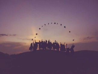 Silhouette of people standing on a hill