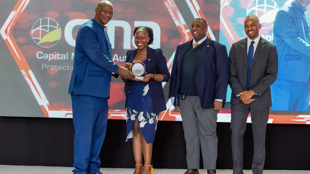 The SBG Securities team, led by Chief Executive Grace Semakula (right), pose for a photo after receiving the award.