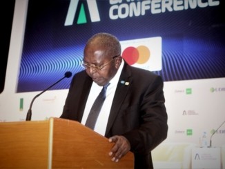 A man at a podium addressing a conference