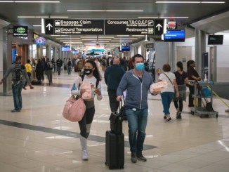 Coronavirus: Flyers at an American airport wearing facemasks