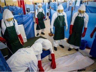 Health care workers learn how to properly dispose of the remains of a simulated patient who died from Ebola