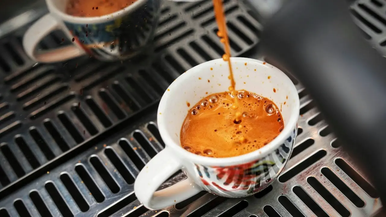 A cup of espresso being made in a café