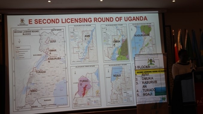 Uganda's minister for energy, Irene Muloni, stands next to a map showing the five oil blocks she had just opened for licensing at the East African Petroleum Conference in Mombasa