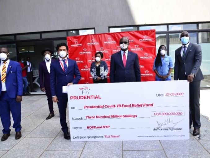 Prudential Uganda executives pose with a dummy cheque